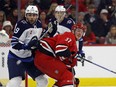 Carolina Hurricanes' Andrei Svechnikov (37) and Winnipeg Jets' Alex Iafallo (9) watch the puck during the first period of an NHL hockey game in Raleigh, N.C., Saturday, March 2, 2024.