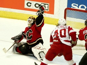 Flames goalie Miikka Kiprusoff reached for a shot from the Detroit Red Wings during Game 6 of their second-round playoff series in 2004.