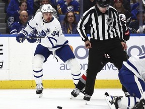 Toronto Maple Leafs center Auston Matthews (34) skates toward a loose puck during the second period of an NHL hockey game against the Buffalo Sabres, Saturday, March 30, 2024, in Buffalo, N.Y.