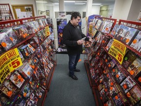 Glen Fuhl, president and CEO of Video King, is photographed as he organizes shelves in one of his stores in Winnipeg Thursday, March 7, 2024. Fuhl is planning to close up shop after forty years in the movie business. April 6 will be the day he turns off the lights for good.