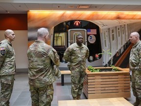 Members of the Armed Forces, including the National Guard, wait in the lobby of the New York City Mass Transit Authority Rail Control Center before the start of a news conference with Gov. Hochul, Wednesday, March 6, 2024.