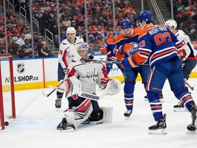 Edmonton Oilers Ryan Nugent-Hopkins (93) and Zach Hyman (18) watch Connor McDavid's (97) goal go in against Washington Capitals goalie Darcy Kuemper (35) during first period NHL action on Wednesday, March 13, 2024 in Edmonton. Greg Southam-Postmedia