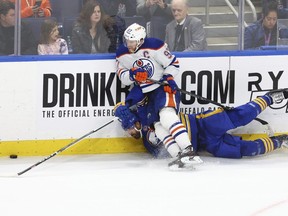 Buffalo Sabres right wing Alex Tuch (89) is checked by Edmonton Oilers center Connor McDavid (97) during the third period of an NHL hockey game Saturday, March 9, 2024, in Buffalo, N.Y.