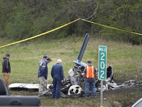 Investigators look over a small plane crash alongside eastbound Interstate 40 at mile marker 202 on Tuesday, March 5, 2024, in Nashville, Tenn.