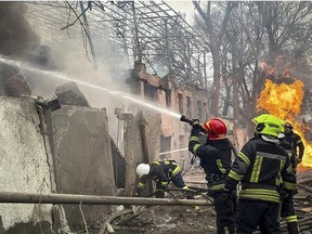In this photo provided by the Ukrainian Emergency Service, emergency services firefighters extinguish a fire at the scene of a Russian attack in Odesa, Ukraine, Friday, March 15, 2024. A Russian missile strike on Odesa in southern Ukraine on Friday killed at least 14 people and injured 46 others, local officials said. (Ukrainian Emergency Service via AP)