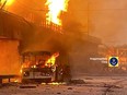 In this photo provided by Petro Andryuschenko, the adviser of the head of Mariupol city's administration, burning trolleybus is seen on the damp of hydroelectric power station after Russian attacks in Dnipro, Ukraine, Friday, March 22, 2024. Over 60 drones and almost 90 missiles of various types were fired that night, Ukrainian officials said. (Telegram Channel of Petro Andryuschenko, the adviser of the head of Mariupol city's administration via AP)