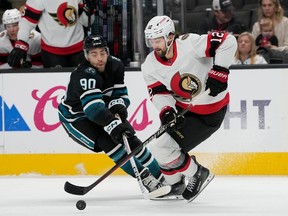 Senators center Mark Kastelic skates with the puck against Sharks right-winger Justin Bailey during the first period of Saturday's game in San Jose.