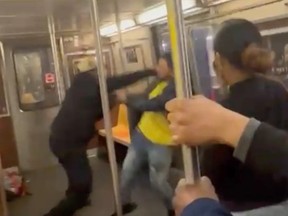 Two unidentified people fight on the subway in Brooklyn.