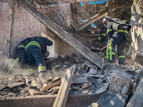 This handout photograph taken and released by Ukrainian Emergency Service on March 28, 2024, shows rescuers working at the site of a missile attack in Mykolaivka, Donetsk.