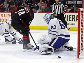 Carolina Hurricanes' Seth Jarvis has his shot deflect wide of Toronto Maple Leafs goaltender Joseph Woll during the second period in Raleigh, N.C., on Sunday, March 24, 2024.