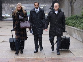 Umar Zameer (centre) is pictured leaving the 361 University Ave. courthouse on March 19, 2024, with his lawyers, Alexandra Heine and Nader Hasan. (Jack Boland, Toronto Sun)