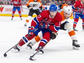 Canadiens' Josh Anderson shields the puck from Flyers defenceman Adam Ginning during game last week at the Bell Centre.