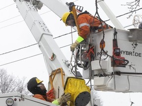 Hydro Quebec crew works on power lines to re-establish power at the corner of Jean Talon and St Michel on Thursday April 4, 2024 following spring snowstorm that hit the city overnight.