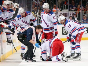 Mika Zibanejad of the New York Rangers is attended during Tuesday's game against the Islanders.