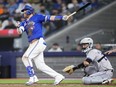 Justin Turner of the Toronto Blue Jays hits an RBI double against the Colorado Rockies during the third inning in their MLB game at the Rogers Centre on April 14, 2024 in Toronto.