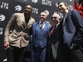 Toronto Raptors president Masai Ujiri (L) introduces their new head coach Darko Rajakovic with Larry Tanenbaum and general manager Bobby Webster. outside the ScotiaBank Arena.