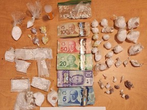 A witness spotted three large black cases buried near a local Prince George trail on April 1, 2024, and police recovered a large cache of drugs and cash inside.