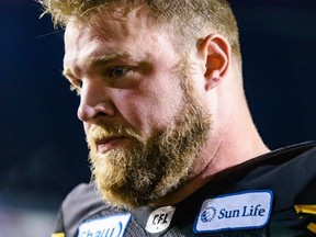 Hamilton Tiger-Cats Chris Van Zeyl walks out of the field with an unbelieving look on his face after his team loses against Winnipeg Blue Bombers during the Grey Cup CFL championship football game on Sunday, November 24, 2019.
