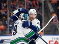 Defenceman Ian Cole gives Casey DeSmith a hug after the Canucks' back-up goalie made 37 saves in a 4-3 win at Edmonton on Oct. 14.