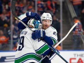 Defenceman Ian Cole gives Casey DeSmith a hug after the Canucks' back-up goalie made 37 saves in a 4-3 win at Edmonton on Oct. 14.