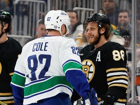 Canucks defenceman Ian Cole gets into an exchange with Bruins winger David Pastrnak during Feb. 8 game in Boston.