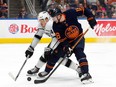 The Edmonton Oilers' Zach Hyman (18) battles the Los Angeles Kings' Mikey Anderson (44) during first period NHL action at Rogers Place in Edmonton Thursday March 28, 2024.