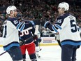 Kyle Connor (81) of the Winnipeg Jets is congratulated by Mark Scheifele (55) after scoring a goal during the first period of the game against the Columbus Blue Jackets at Nationwide Arena on March 17, 2024 in Columbus, Ohio.