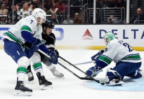 Kevin Fiala of the Los Angeles Kings scores a goal between Casey DeSmith and Carson Soucy of the Vancouver Canucks, to take a 4-1 lead, during the second period at Crypto.com Arena on April 6 in Los Angeles.