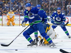 Tyler Myers of the Vancouver Canucks checks a Nashville Predators player in Game One of the First Round of the 2024 Stanley Cup Playoffs at Rogers Arena on April 21, 2024 in Vancouver.