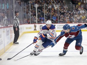 Connor Brown #28 of the Edmonton Oilers advances the puck against Devon Toews #7 of the Colorado Avalanche in the first period at Ball Arena on April 18, 2024 in Denver, Colorado.
