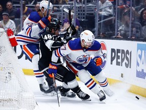 LOS ANGELES, CALIFORNIA - APRIL 28: Brett Kulak #27 of the Edmonton Oilers skates the puck against Blake Lizotte #46 of the Los Angeles Kings in the second period during Game Four of the First Round of the 2024 Stanley Cup Playoffs at Crypto.com Arena on April 28, 2024 in Los Angeles, California.