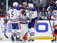 Cody Ceci (5), Stuart Skinner (74) and Leon Draisaitl (29) of the Edmonton Oilers celebrate a 1-0 win against the Los Angeles Kings in Game 4 of their first round of the 2024 Stanley Cup Playoffs at Crypto.com Arena on April 28, 2024, in Los Angeles, Calif.