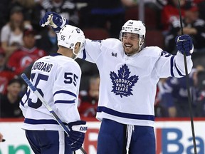 Mark Giordano #55 of the Toronto Maple Leafs is congratulated by teammate Auston Matthews #34 after Giordano scored during the second period against the New Jersey Devils react at Prudential Center on April 9, 2024 in Newark, N.J.