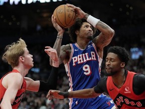 Philadelphia 76ers guard Kelly Oubre Jr. (9) drives to the hoop between Toronto Raptors guard Kobi Simmons (8) and teammate Gradey Dick (1) during second half NBA basketball action in Toronto, Sunday, March 31, 2024.