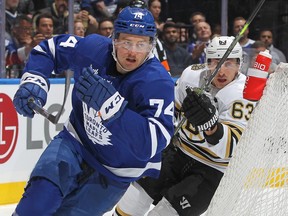 Bobby McMann #74 of the Toronto Maple Leafs skates against Brad Marchand.