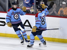 Winnipeg Jets' Cole Perfetti (91) celebrates his goal against the Los Angeles Kings with Nate Schmidt (88) during the third period of NHL action in Winnipeg on Monday April 1, 2024. THE CANADIAN PRESS/Fred Greenslade