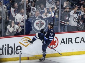 Winnipeg Jets' Nikita Chibrikov celebrates his game-winning goal against the Vancouver Canucks during third period NHL action in Winnipeg on Thursday, April 18, 2024. THE CANADIAN PRESS/John Woods