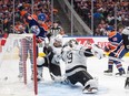 Los Angeles Kings goalie Cam Talbot (39) is scored on by Edmonton Oilers forward Zach Hyman (18) as Mikey Anderson (44) and Adam Henrique (19) fight for position in their first-round NHL Stanley Cup playoff series in Edmonton on April 22, 2024.