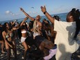 A group of students from the University of Mississippi dance and sing as they enjoy spring break on South Beach, Friday, March 15, 2024, in Miami Beach, Fla.