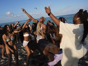 A group of students from the University of Mississippi dance and sing as they enjoy spring break on South Beach, Friday, March 15, 2024, in Miami Beach, Fla.