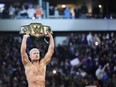 Cody Rhodes raises the Undisputed WWE Universal Championship belt after defeating Roman Reigns to win it on Night 2 of WrestleMania 40 at Lincoln Financial Field in Philadelphia, Pa.