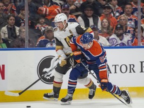 Dylan Holloway (55) of the Edmonton Oilers gets position on Jack Eichel (9) of the Las Vegas Golden Knights at Rogers Place in Edmonton on April 10, 2024.