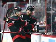 Jaccob Slavin, right, and Jack Drury of the Carolina Hurricanes celebrate after a win against the New York Islanders in Game Five of the First Round of the 2024 Stanley Cup Playoffs at PNC Arena on April 30, 2024 in Raleigh, N.C.