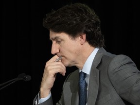 Prime Minister Justin Trudeau reads a document presented to him by counsel at the Public Inquiry Into Foreign Interference in Federal Electoral Processes and Democratic Institutions in Ottawa on Wednesday, April 3, 2024.
