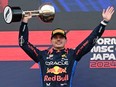 Red Bull Racing's Dutch driver Max Verstappen celebrates on the podium after the end of the Formula One Japanese Grand Prix race at the Suzuka circuit in Suzuka, Mie prefecture on April 7, 2024.