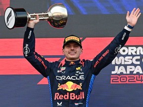 Red Bull Racing's Dutch driver Max Verstappen celebrates on the podium after the end of the Formula One Japanese Grand Prix race at the Suzuka circuit in Suzuka, Mie prefecture on April 7, 2024.