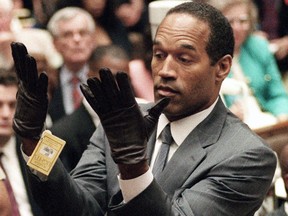 In this June 21, 1995 file photo, O.J. Simpson holds up his hands before the jury after putting on a new pair of gloves
