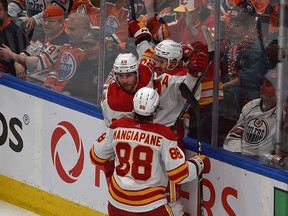 Calgary Flames Mikael Backlund (11) celebrates his goal with Andrew Mangiapane (88) and Blake Coleman (20) against the Edmonton Oilers during NHL playoff action at Rogers Place in Edmonton on May 24, 2022.