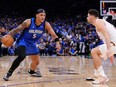 Paolo Banchero, left, of the Orlando Magic dribbles the ball against Georges Niang of the Cleveland Cavaliers during the first quarter of game three of the Eastern Conference First Round Playoffs at Kia Center on April 25, 2024 in Orlando, Fla.