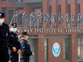Security personnel keep watch outside the Wuhan Institute of Virology during the visit by the World Health Organization (WHO) team tasked with investigating the origins of the coronavirus disease (COVID-19), in Wuhan, Hubei province, China, Feb. 3, 2021.
